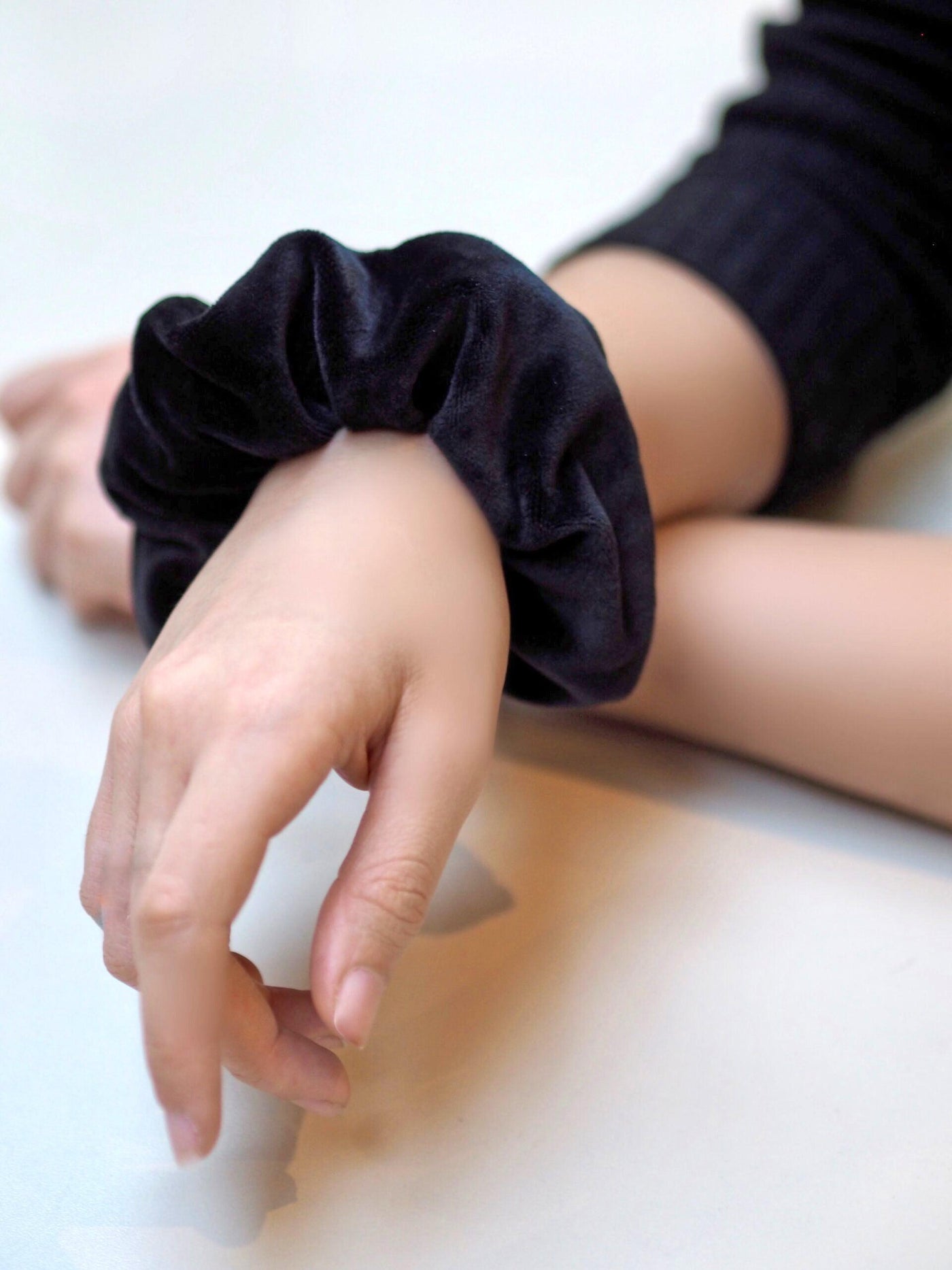 Wear black velvet scrunchy on a wrist